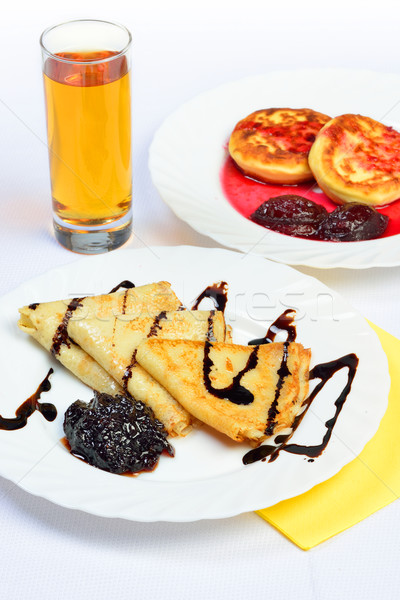 food of crepes, cheesecakes with berry sause and glass of juice. Stock photo © Pilgrimego