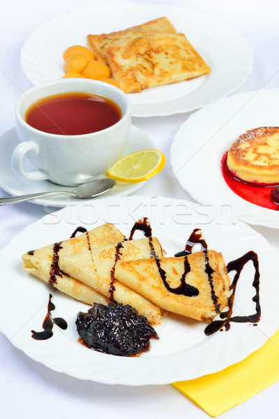Food of Crepes, cheesecakes with berry sause and cup of tee. Stock photo © Pilgrimego