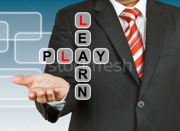 Stock photo: Businessman hand drawing Learn and Play