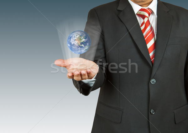 Businessman with earth in his hand. The Earth texture of this im Stock photo © pinkblue