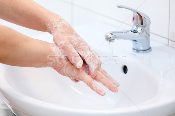 Stock photo: Washing of hands with soap under running water