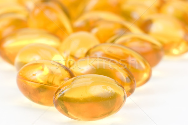 Transparent gold fish oil pills close-up Stock photo © pixelman