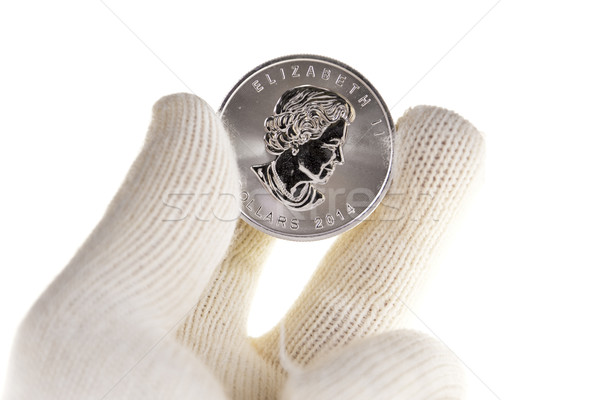 Canadian Silver Coin Investment, one ounce troy, Held in the fingers in white gloves, isolated on wh Stock photo © pixelman