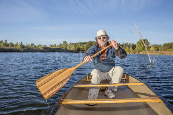 enjoying canoe paddling on lake Stock photo © PixelsAway