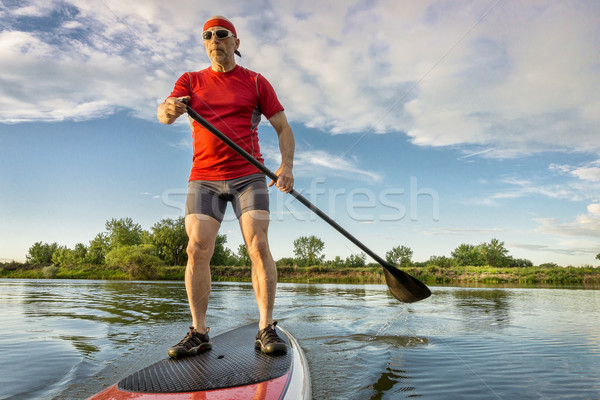 senior athletic paddler on paddleboard Stock photo © PixelsAway