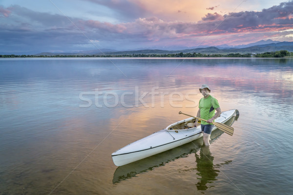 paddler and canoe at dusk Stock photo © PixelsAway