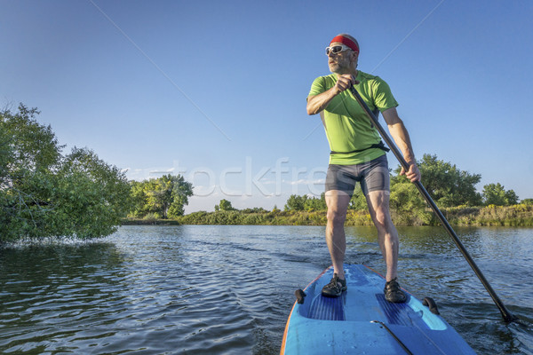 senior male paddler on paddleboard Stock photo © PixelsAway