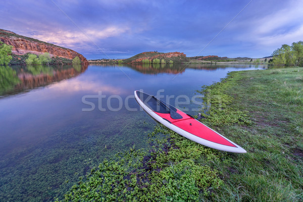 dusk over lake with paddleboard Stock photo © PixelsAway