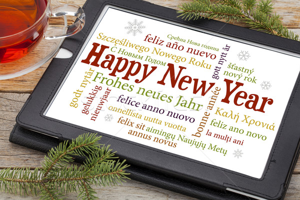 Happy new year différent langues numérique comprimé tasse [[stock_photo]] © PixelsAway