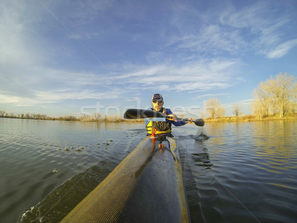 racing kayak against sunset Stock photo © PixelsAway