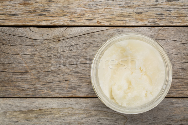 glass jar of coconut cooking oil on grunge  wood table, top view with a copy space Stock photo © PixelsAway
