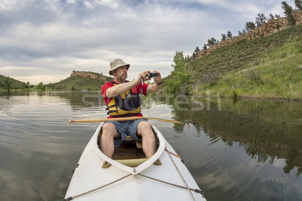 canoe paddler photographing Stock photo © PixelsAway