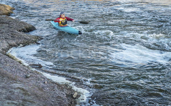 Stock photo: male paddler in a whitewater kayak