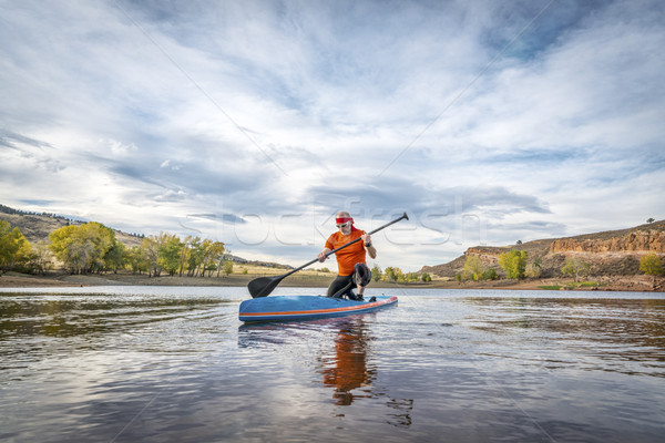 stand up paddling on lake Stock photo © PixelsAway