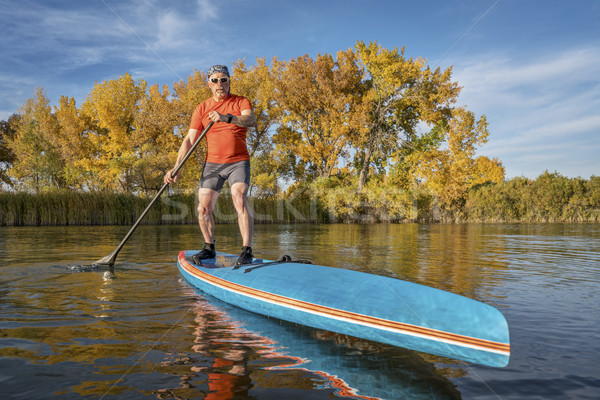 stand up paddling in fall colors Stock photo © PixelsAway