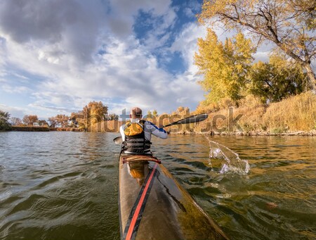 mature male in a canoe Stock photo © PixelsAway