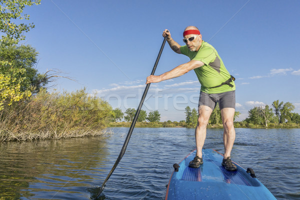 senior male paddler on paddleboard Stock photo © PixelsAway