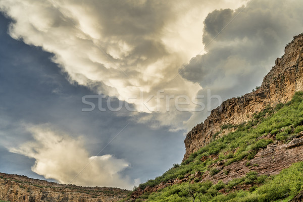 Dramatic clouds over sandstone cliffs  Stock photo © PixelsAway