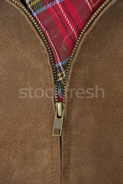 Stock photo: unzipped brass zipper of leather jacket