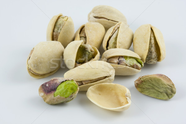 dozen of salted and roasted pistachio nuts Stock photo © PixelsAway