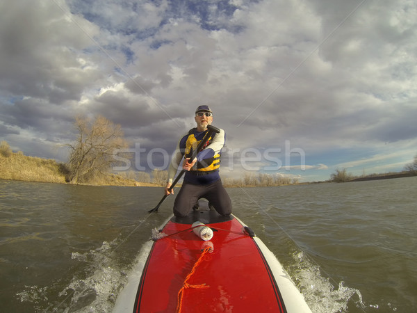 kneeling on stand up paddleboard Stock photo © PixelsAway