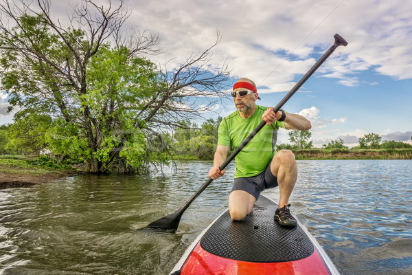 stand up paddling on lake Stock photo © PixelsAway