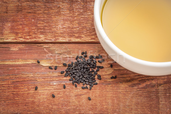 Schwarz Kreuzkümmel Samen Öl wenig Schüssel Stock foto © PixelsAway