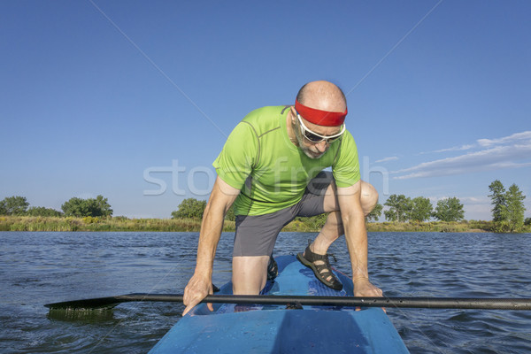 senior male paddler on paddleboard Stock photo © PixelsAway