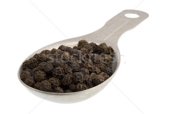 Measuring tablespoon of black peppercorns isolated on white Stock photo © PixelsAway