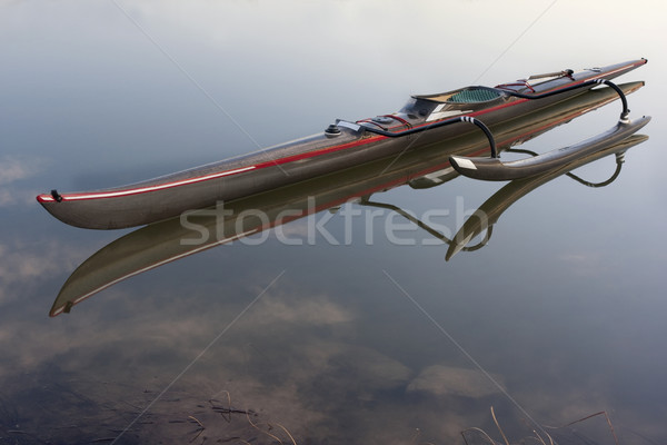 long and slim racing outrigger canoe on a calm lake Stock photo © PixelsAway