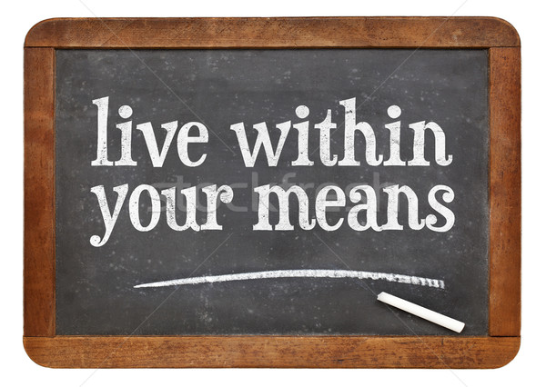 Live within your means blackboard sign Stock photo © PixelsAway