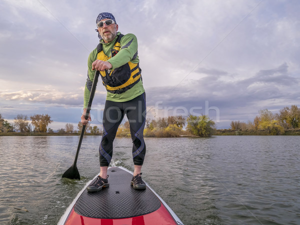 Stock photo: stand up paddling on a lake