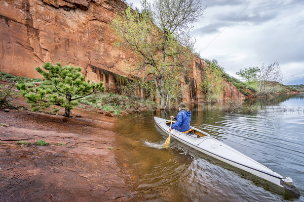 canoe paddler and sandstone cliff Stock photo © PixelsAway