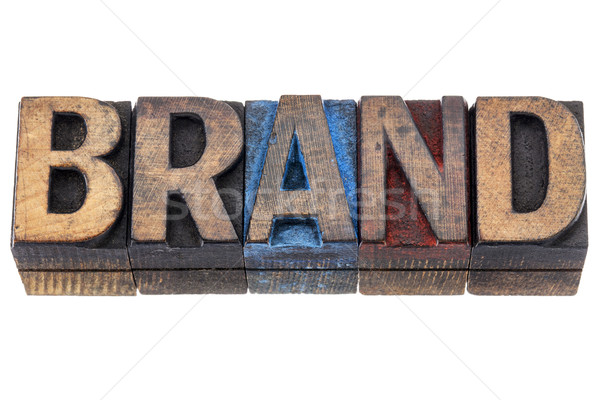 Stock photo: Brand - isolated word in vintage letterpress wood type blocks stained by blue, red, and black ink