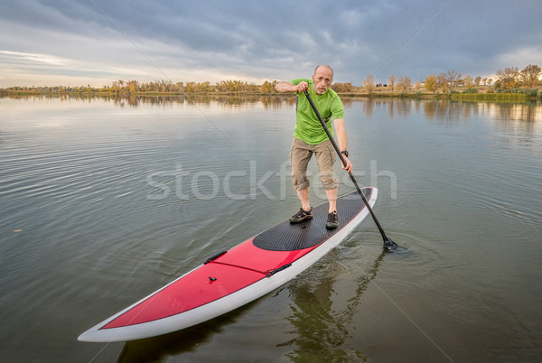 male paddler on stand up paddleboard Stock photo © PixelsAway