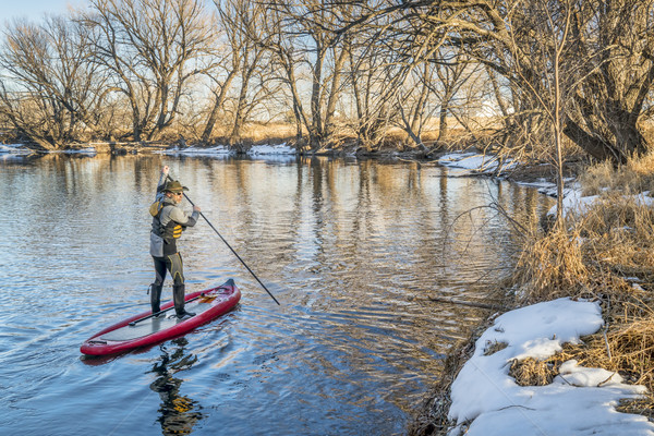 Stand up paddler poling on shallow river  Stock photo © PixelsAway