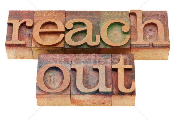 reach out phrase in letterpress type Stock photo © PixelsAway
