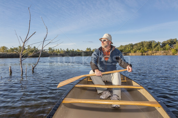 paddling canoe on a lake Stock photo © PixelsAway