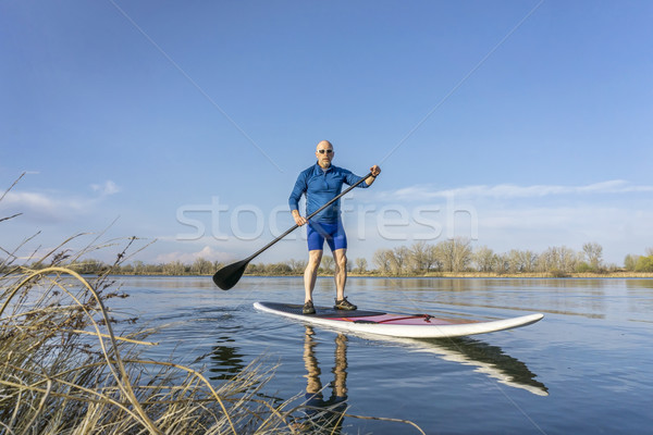 Senior male on SUP paddleboard Stock photo © PixelsAway