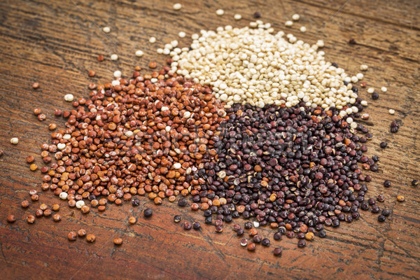 red, white and black guinoa grain on a grunge wood surface Stock photo © PixelsAway