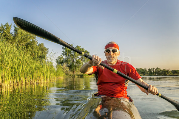 paddling racing sea kayak on lake Stock photo © PixelsAway