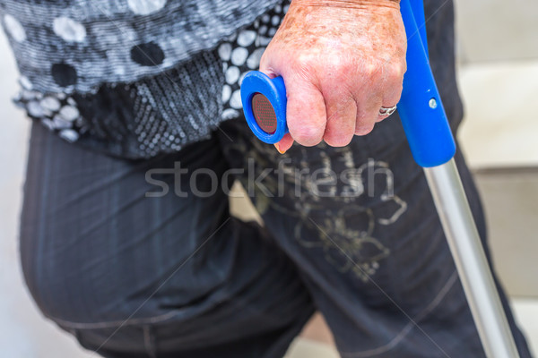 hand of an elderly disabled woman holding a crutch Stock photo © pixinoo