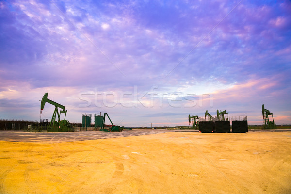 Silhouette of Oil pumps at oil field with sunset sky background Stock photo © pixinoo