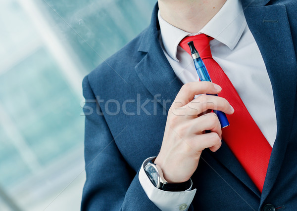 Portrait of cheerful guy smoking with e-cigarette Stock photo © pixinoo