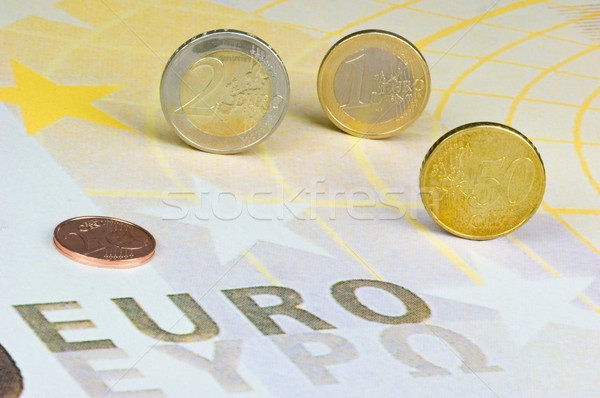 Euro coins rolling over a 200-euro-banknote Stock photo © pixpack