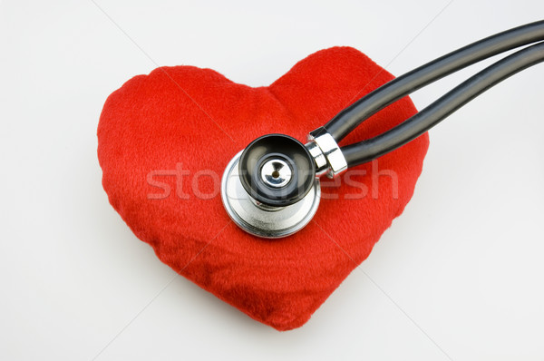 Stock photo: Stethoscope on a red fabric heart