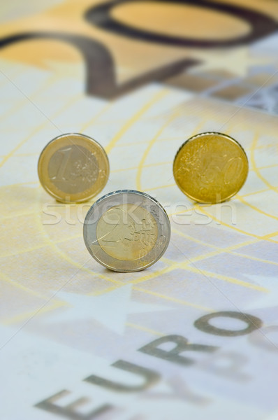 Euro coins rolling over a 200-Euro-banknote Stock photo © pixpack