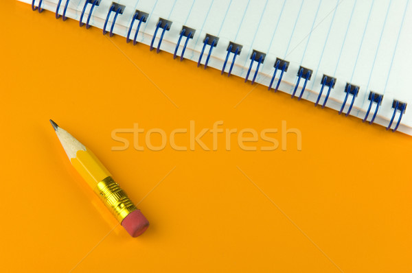 Short pencil a notepad on yellow ground Stock photo © pixpack