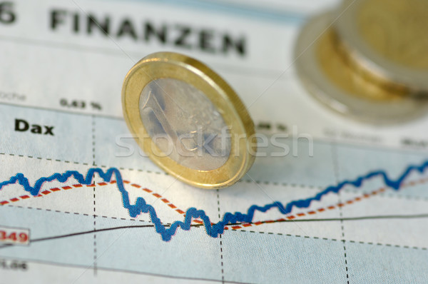 Euro coins rolling over a chart Stock photo © pixpack