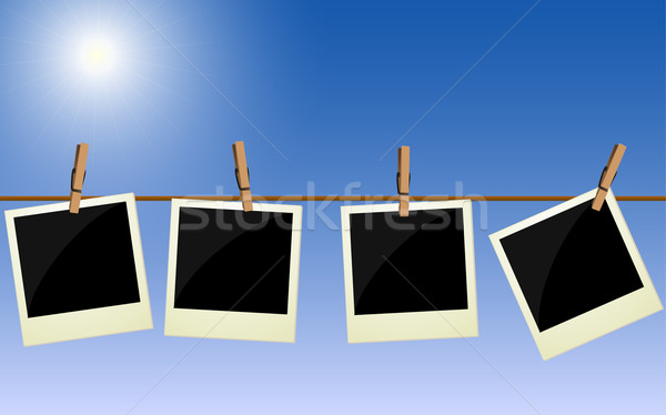 Four polaroid pictures hanging on rope against bright sky Stock photo © PiXXart